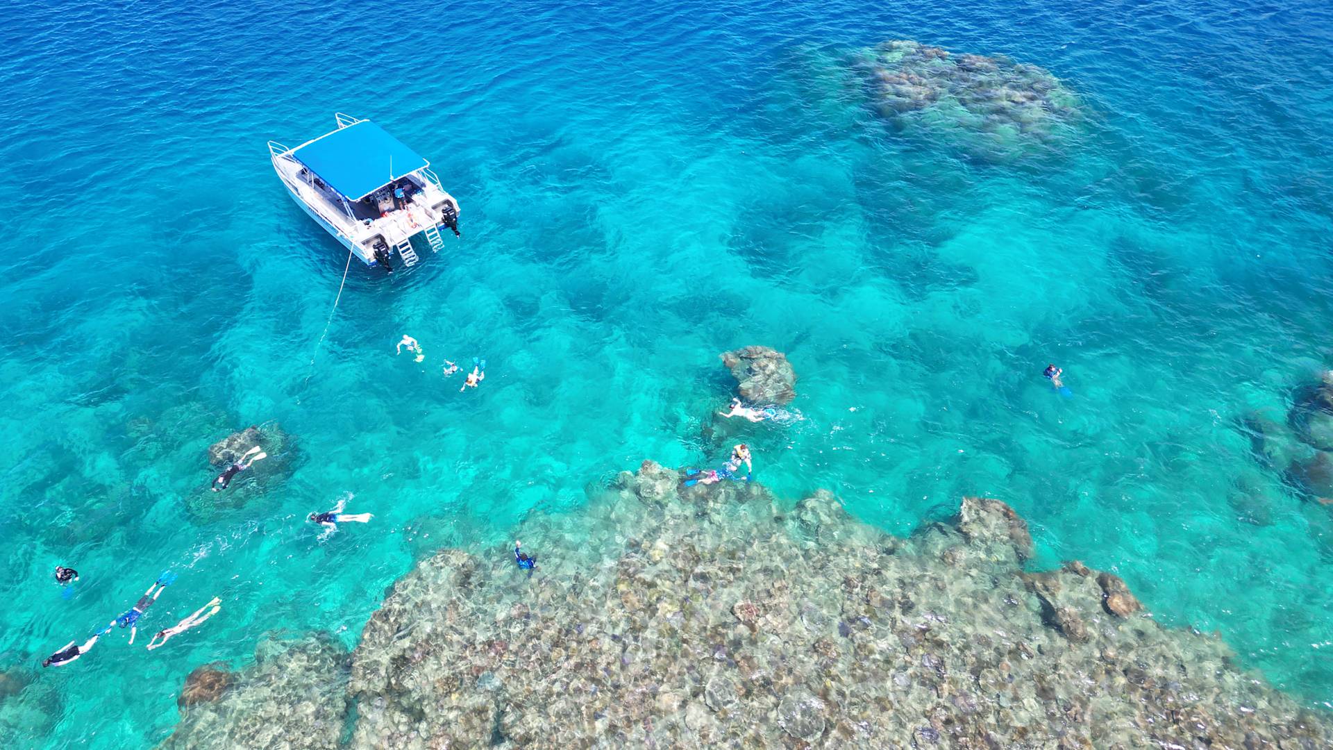 Boat surrounded by water and bathers