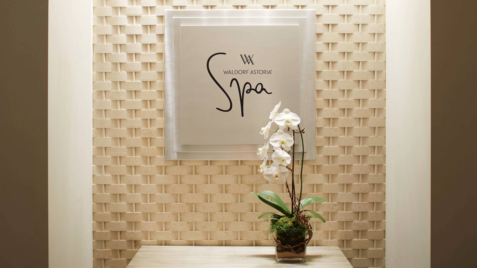 spa entrance sign, white orchid flowers in a pot