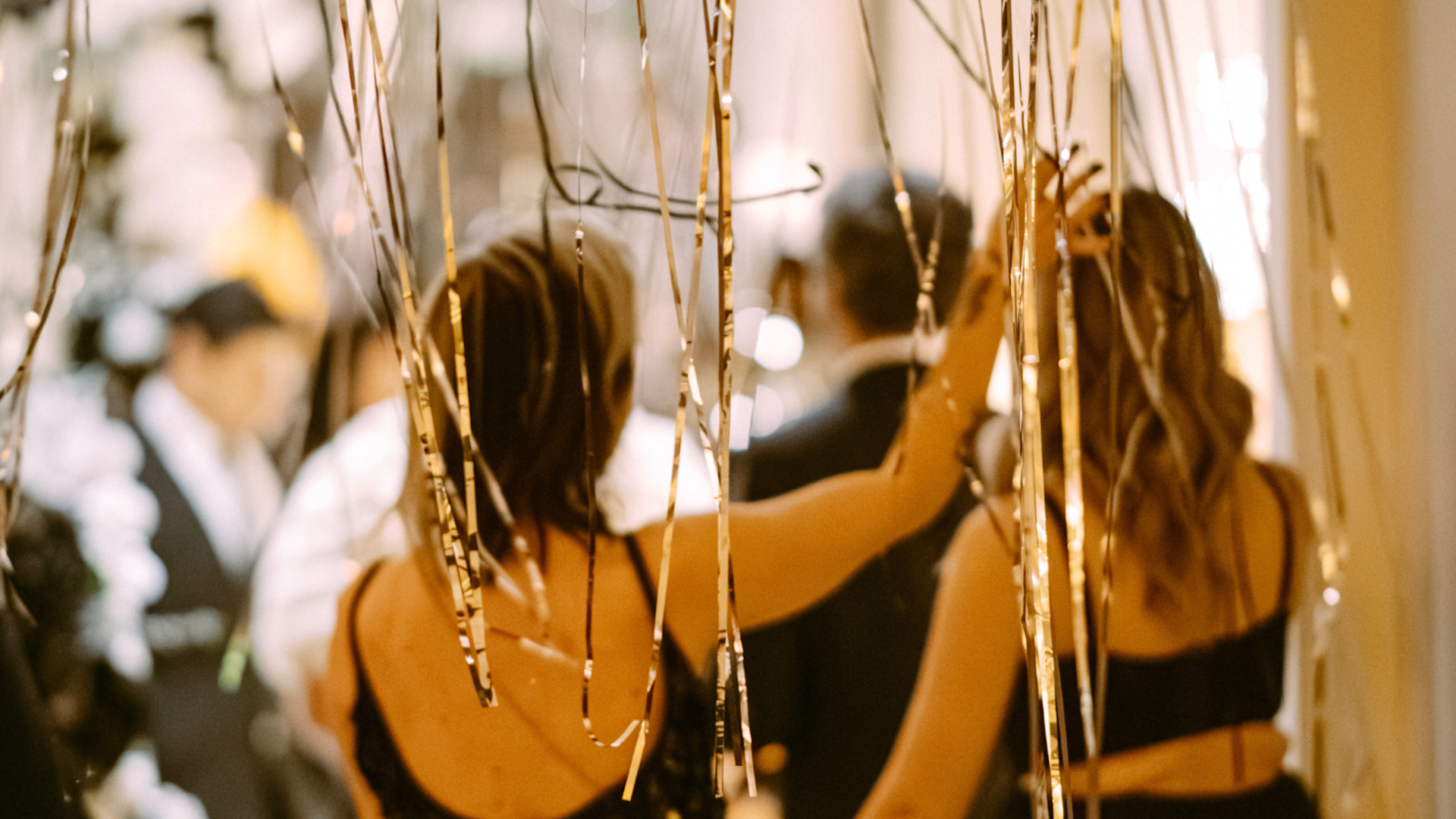 Close up image of two women walking from behind