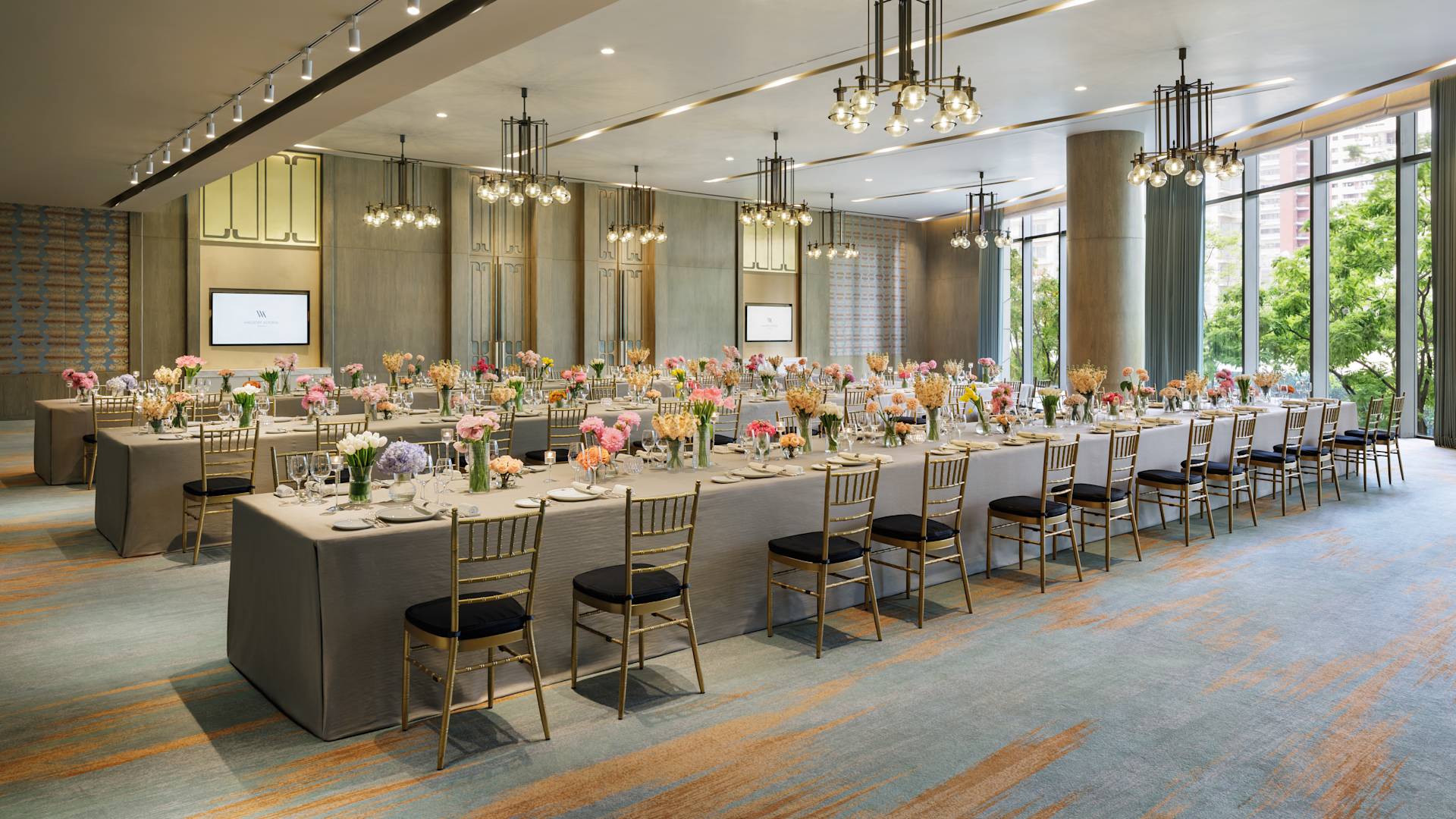 Camellia Meeting Room Setup with Flowers and Large Tables for an Event
