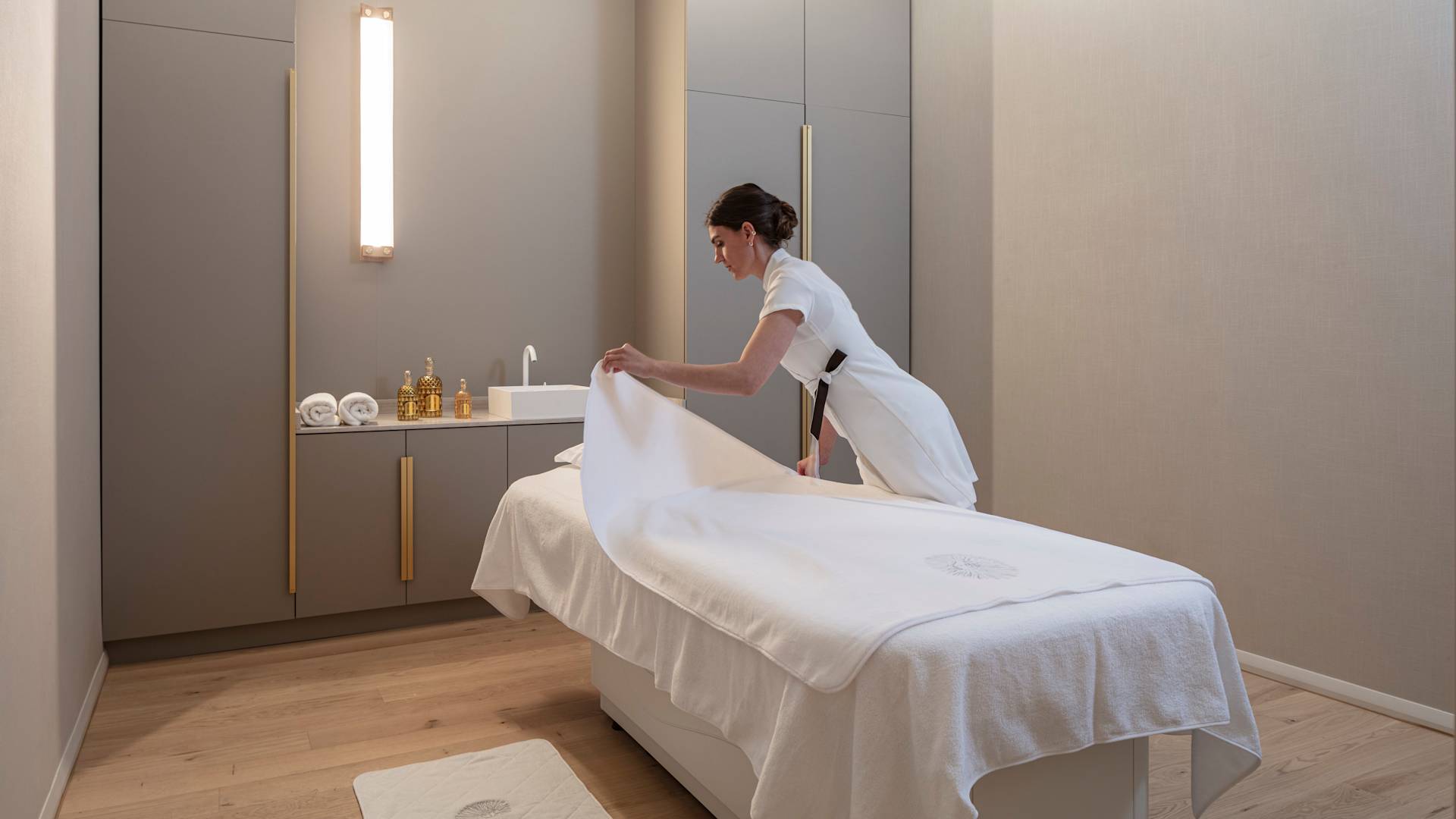Spa Treatment Room With Member Of Staff