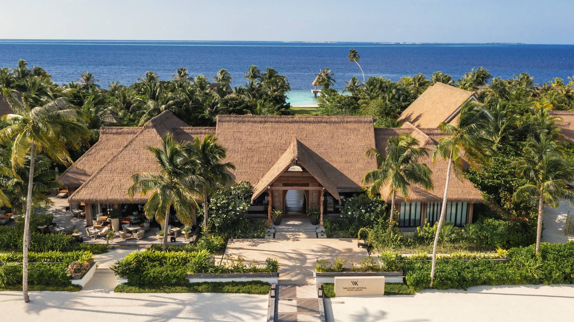 Building entrance with trees and water view