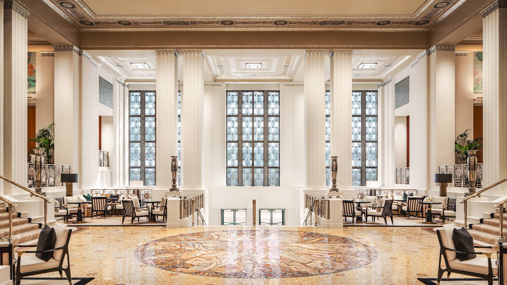 Luxurious lobby area with chairs, pillars and staircases
