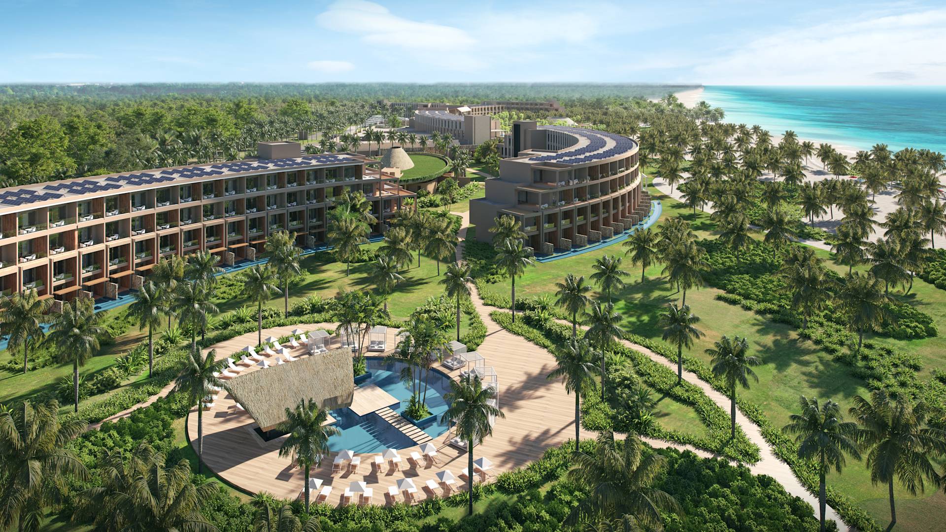 Vue aérienne du complexe, avec bâtiments, arbres et piscine extérieure