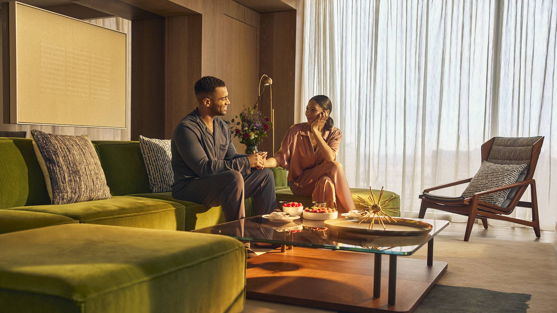 Man and woman relaxing in comfortable seating area with table and chairs-transition