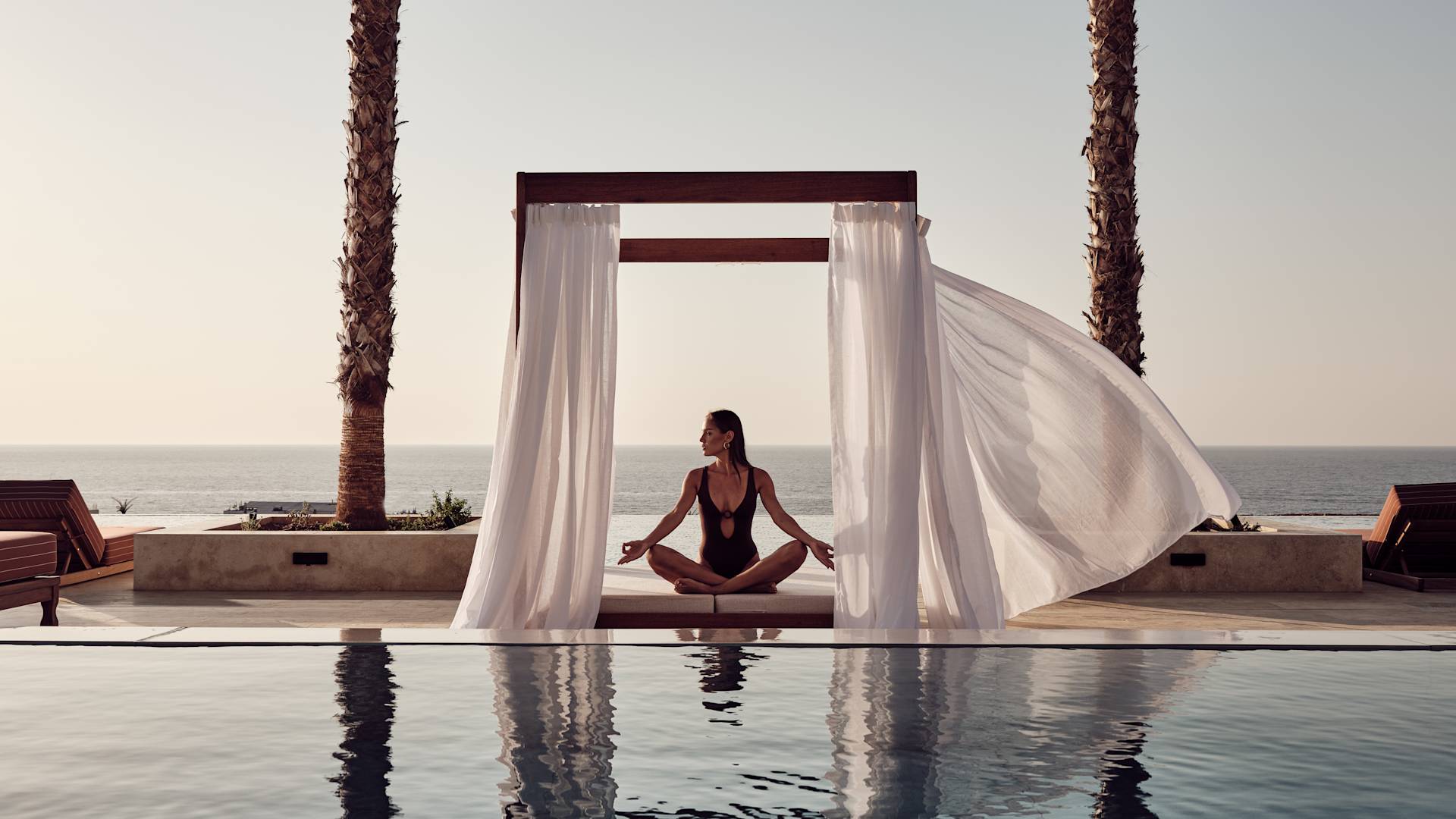 Woman Meditating Outdoors by the Pool in the Evening-transition