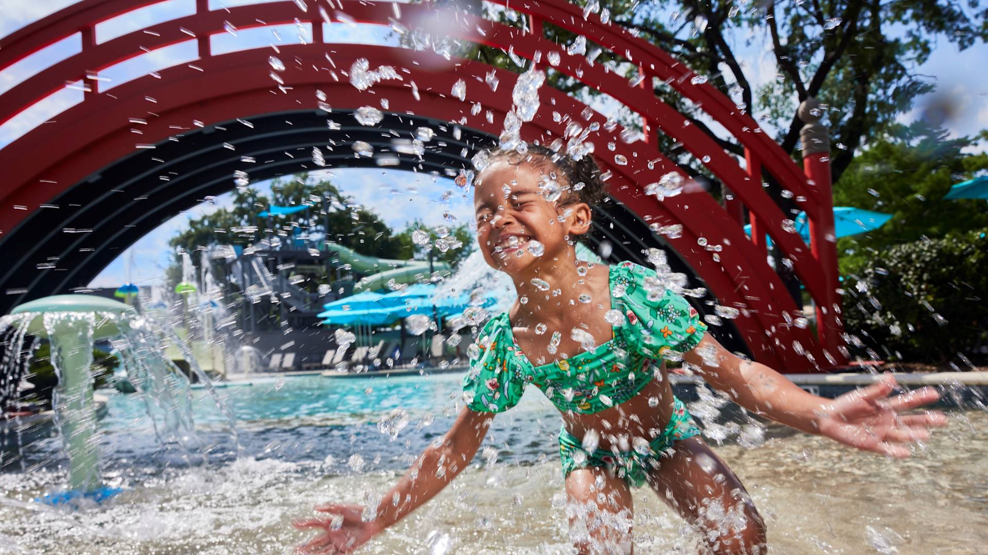little girl splashing in the pool at Jade Waters-transition