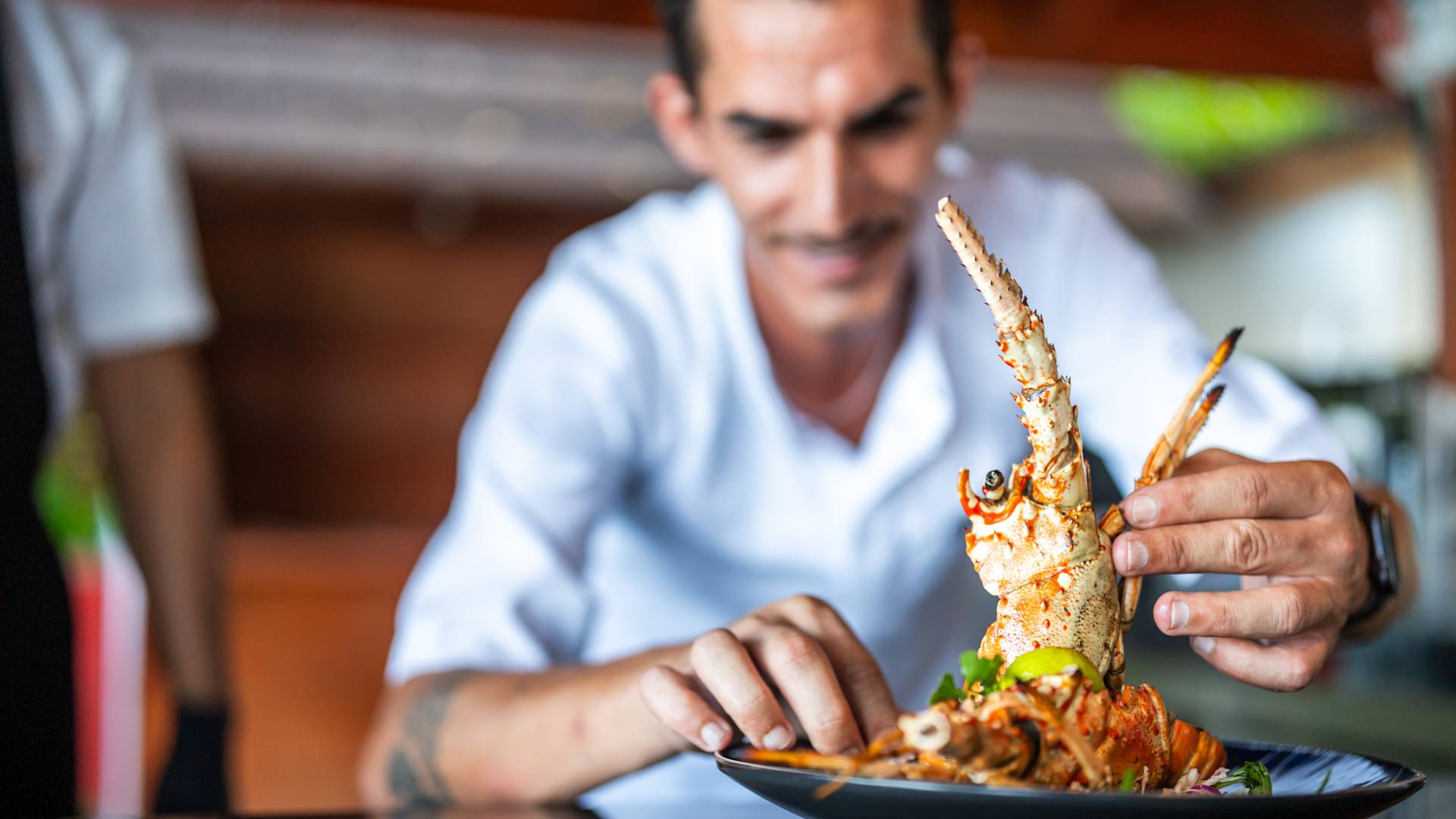 Man Holding Seafood on a Plate at Four Degree Restaurant-transition