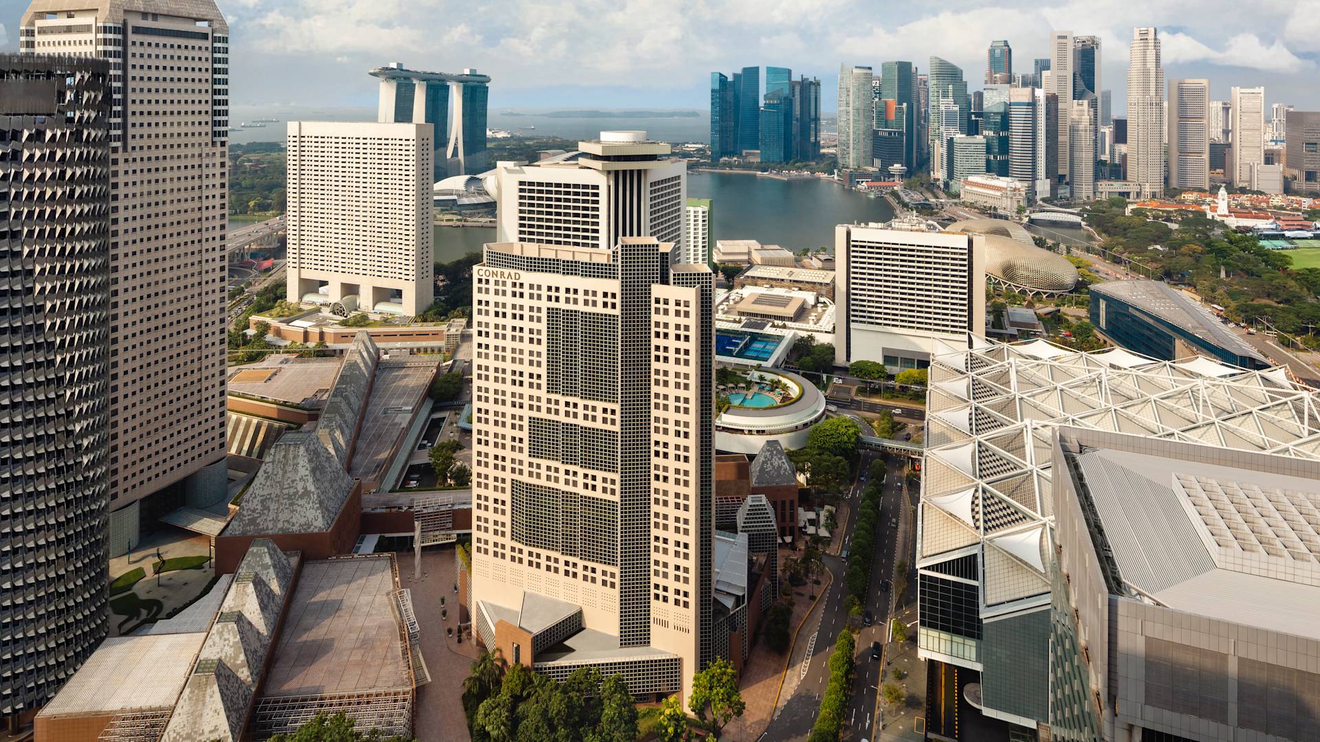 Conrad Singapore Marina Bay hotel exterior, surrounding buildings, view of the bay-transition