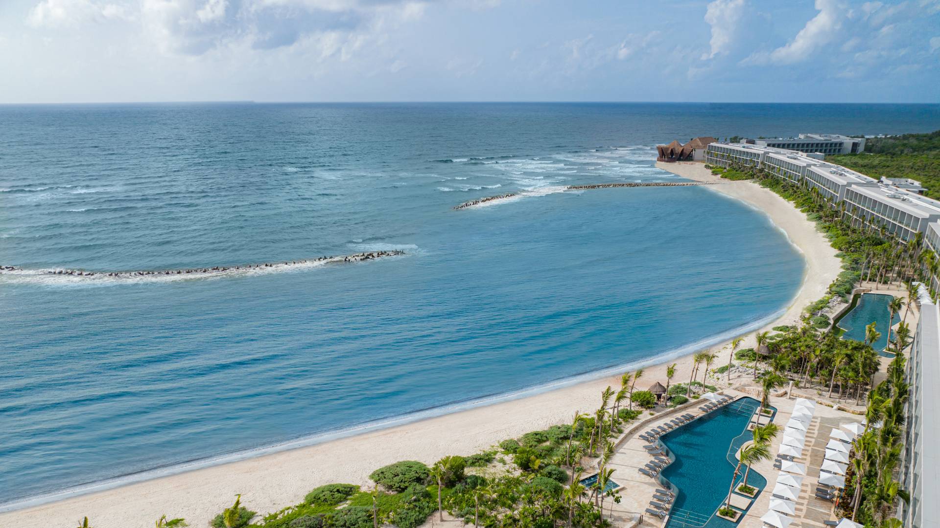 Aerial View of Hilton Tulum Hotel Exterior with Three Large Pool Areas Near the Beach-transition