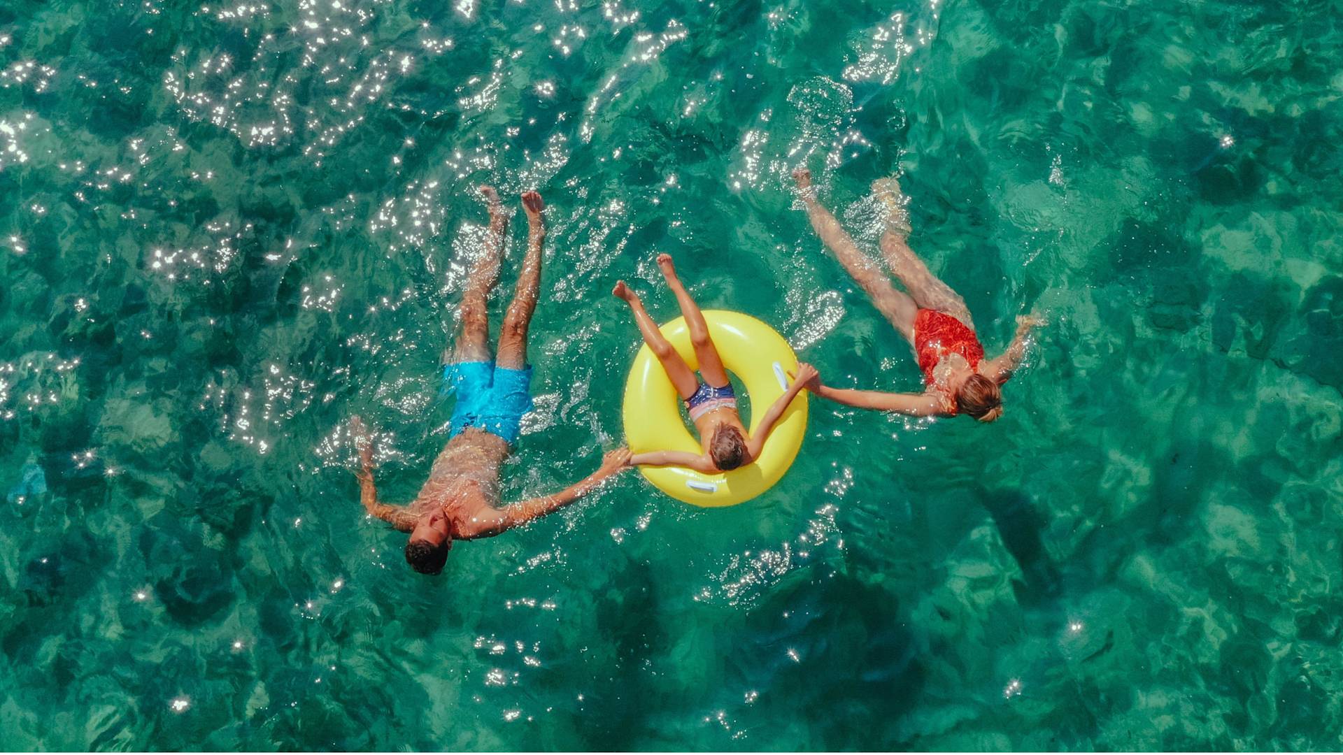 Family Having Fun Swimming at the Beach