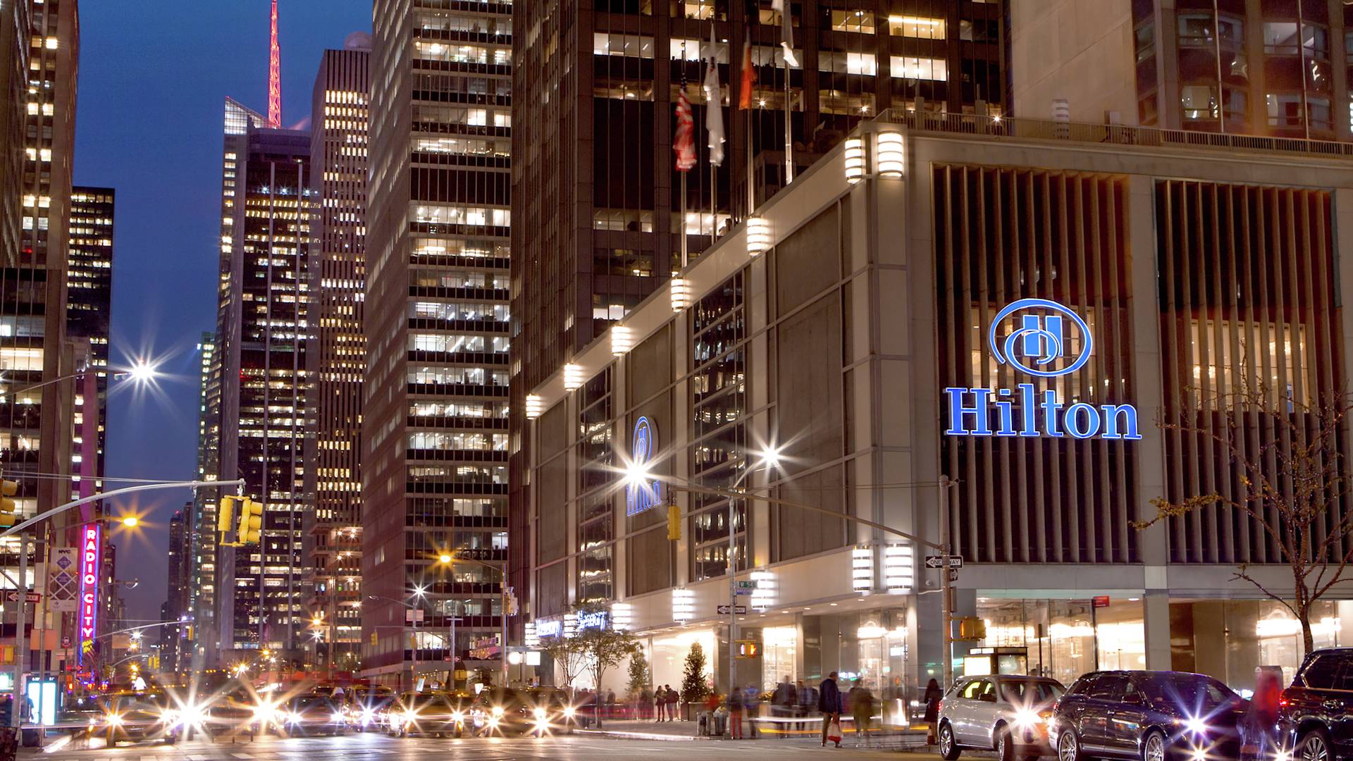 Exterior shot of the New York Hilton Midtown at night.