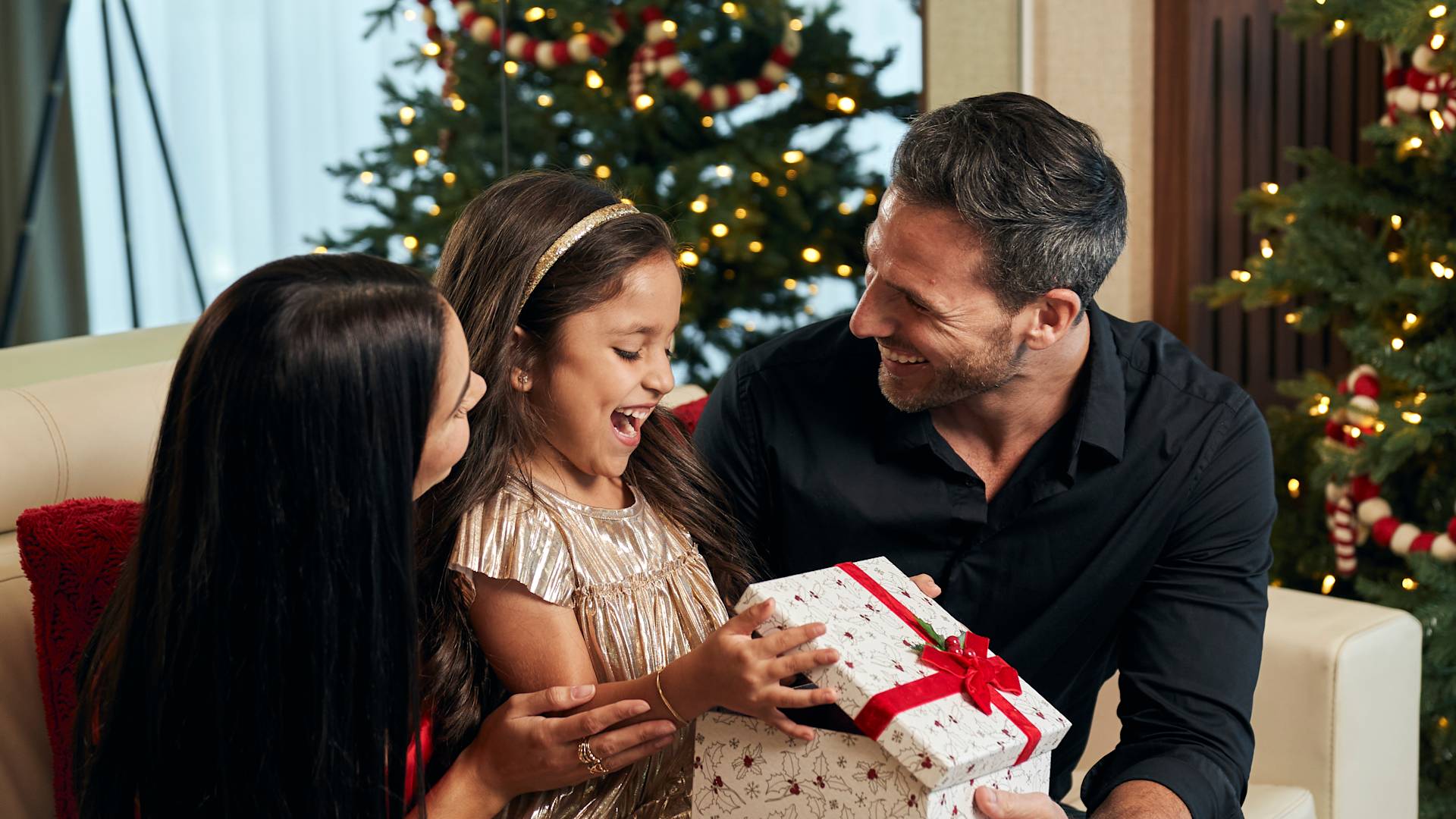 Family Enjoying Christmas Time with Gifts