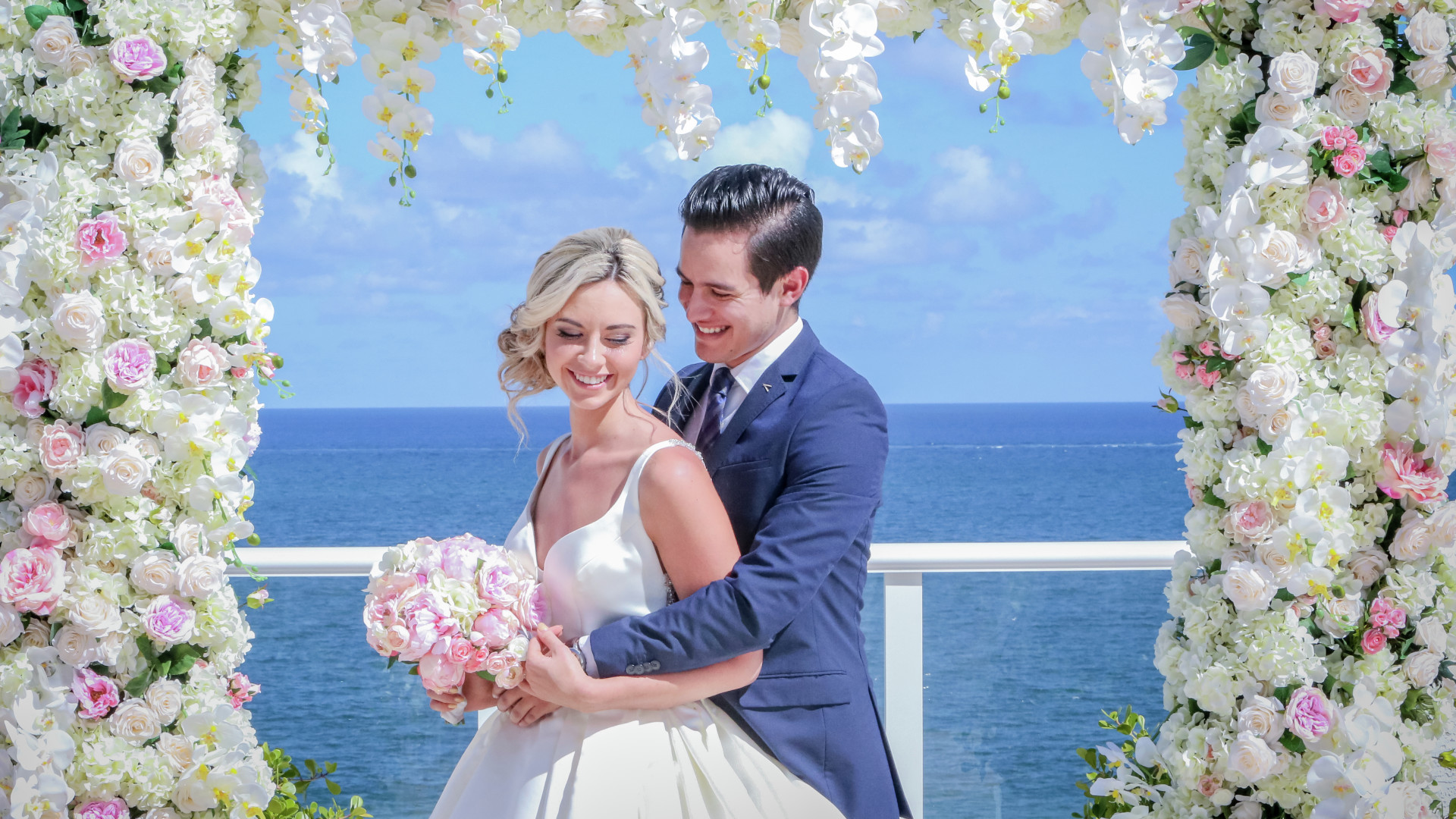 Bride and Groom Standing in Front of Ocean View