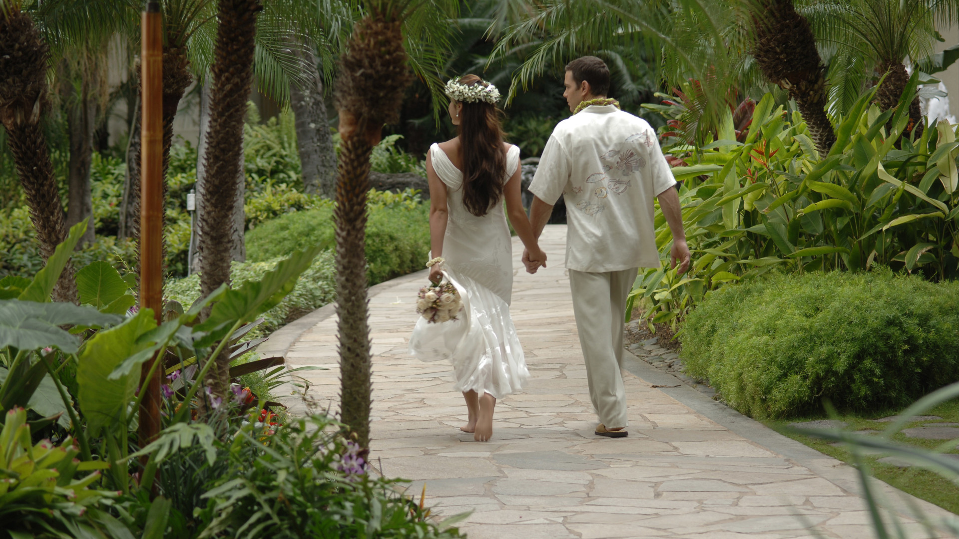 Couple Walking in a Garden Holding Hands