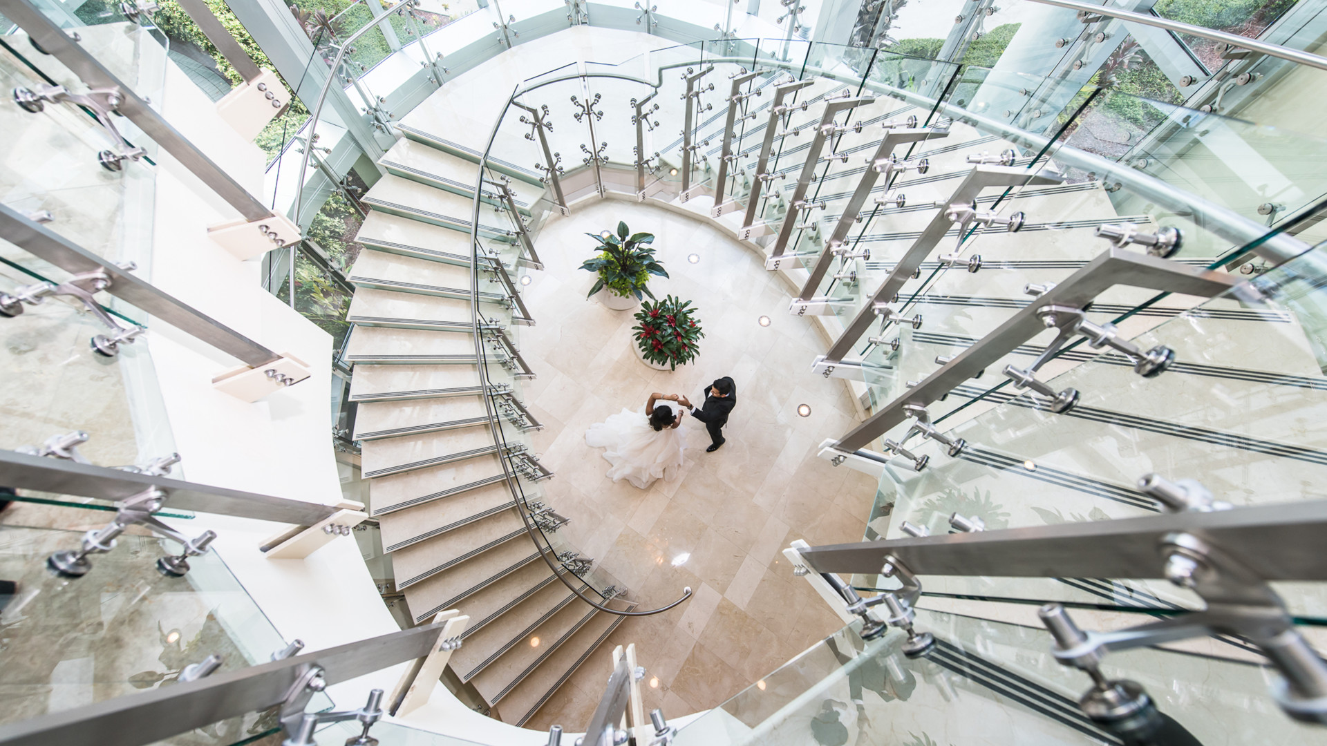 bride & groom dancing by the lobby staircase