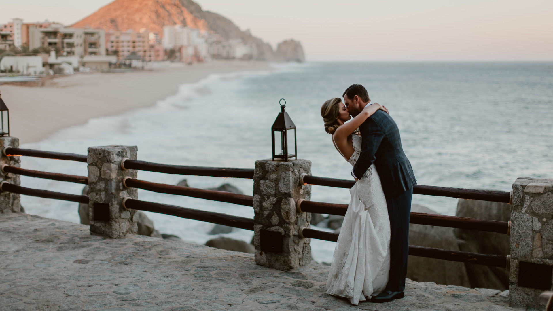 Bride and groom embracing with sea view