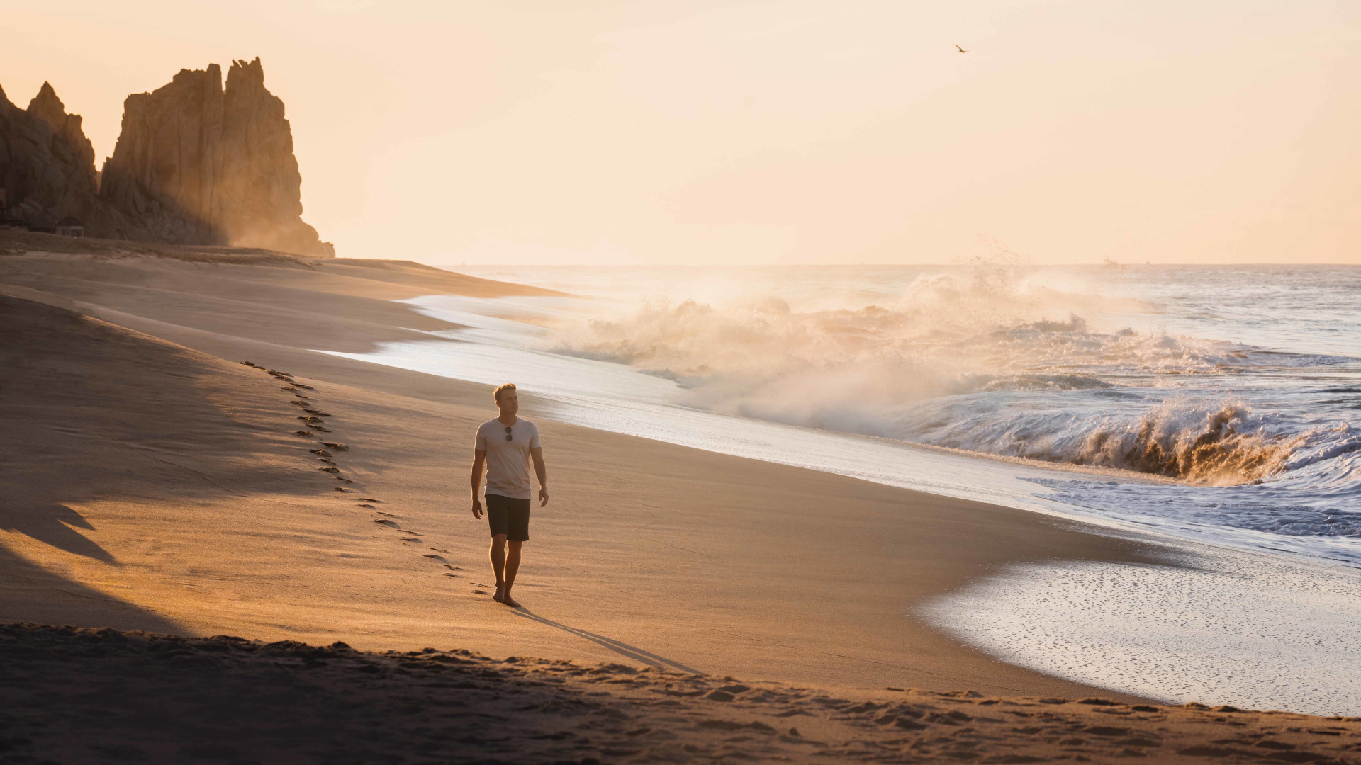 Man walking along the sand