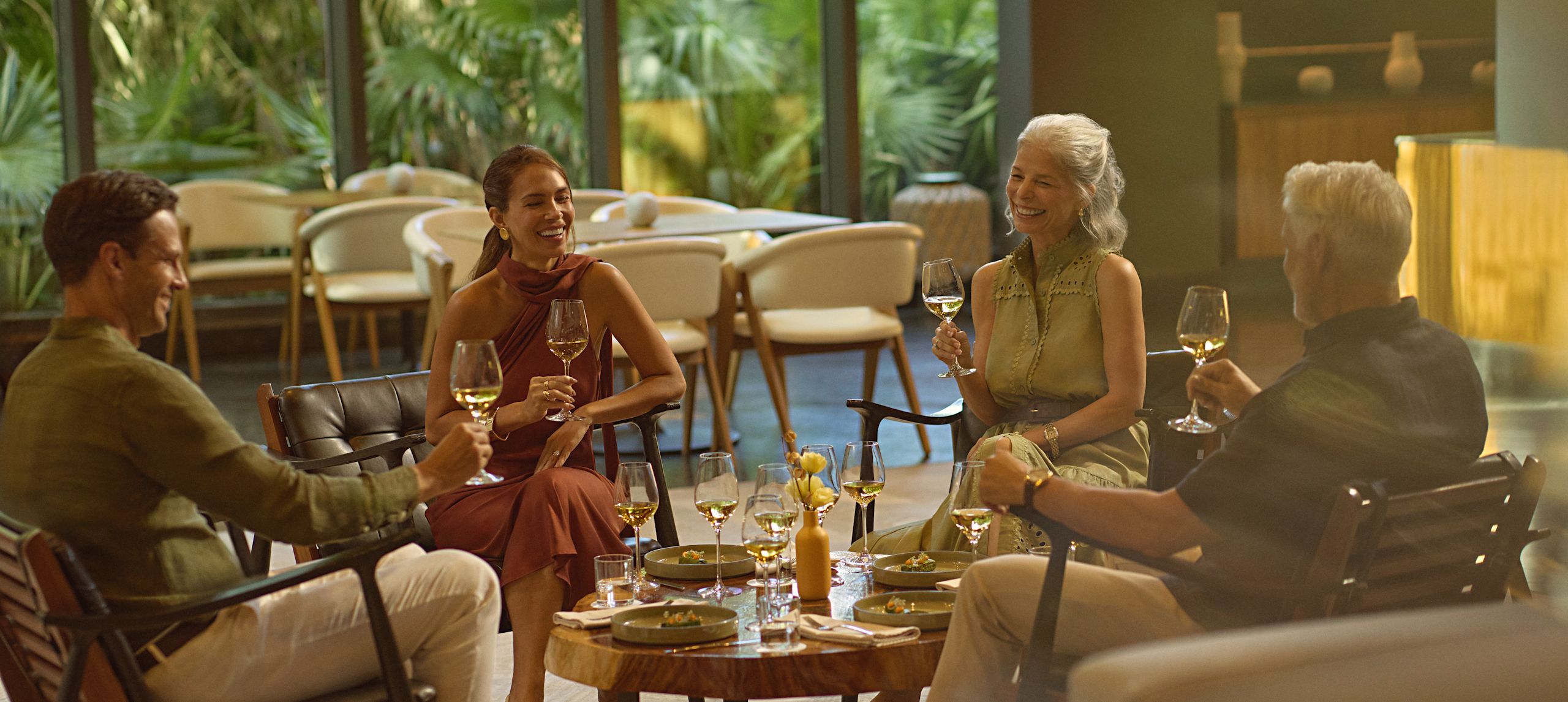 Father, mother and grandparents drinking white wine and enjoying light bites in Ceiba Club