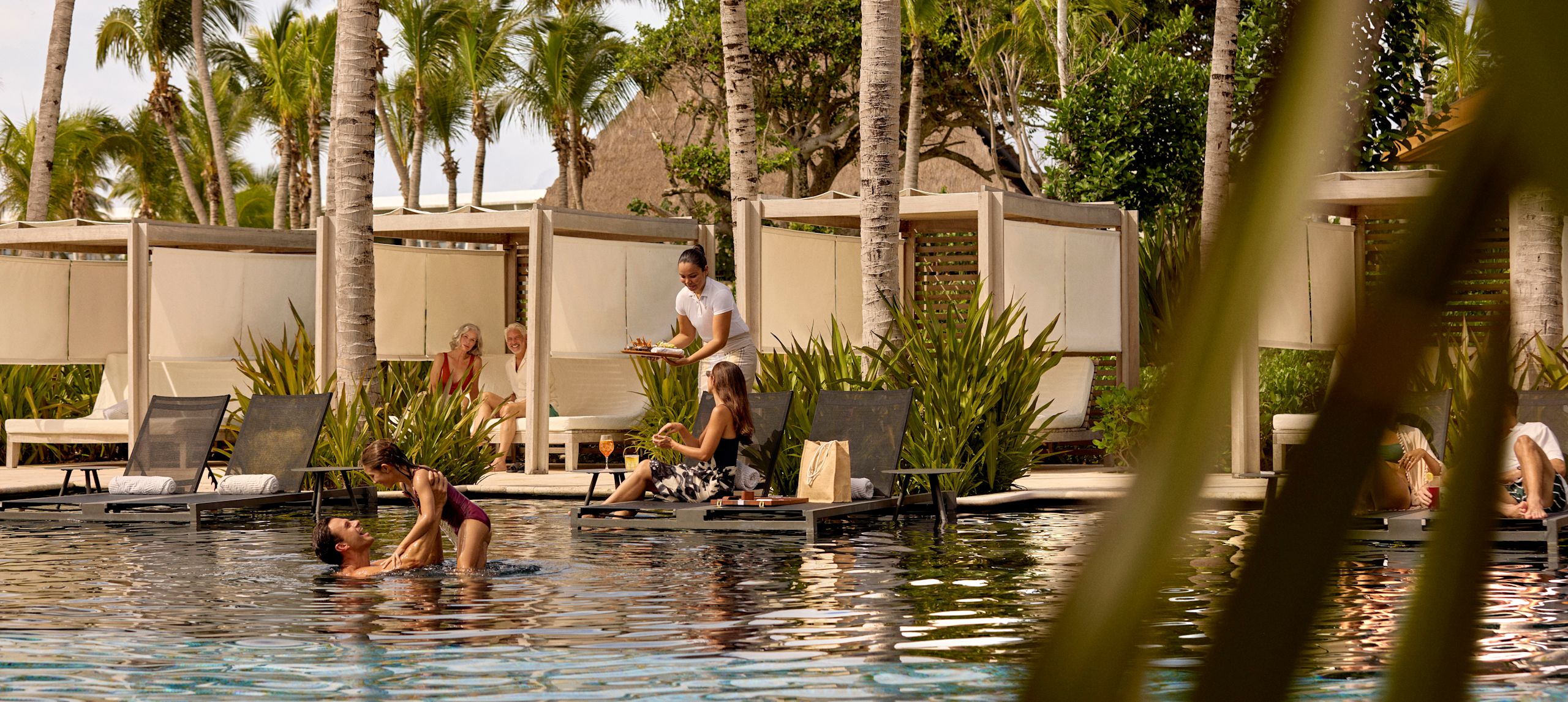 야외 수영장과 일광욕 의자를 즐기는 호텔 고객