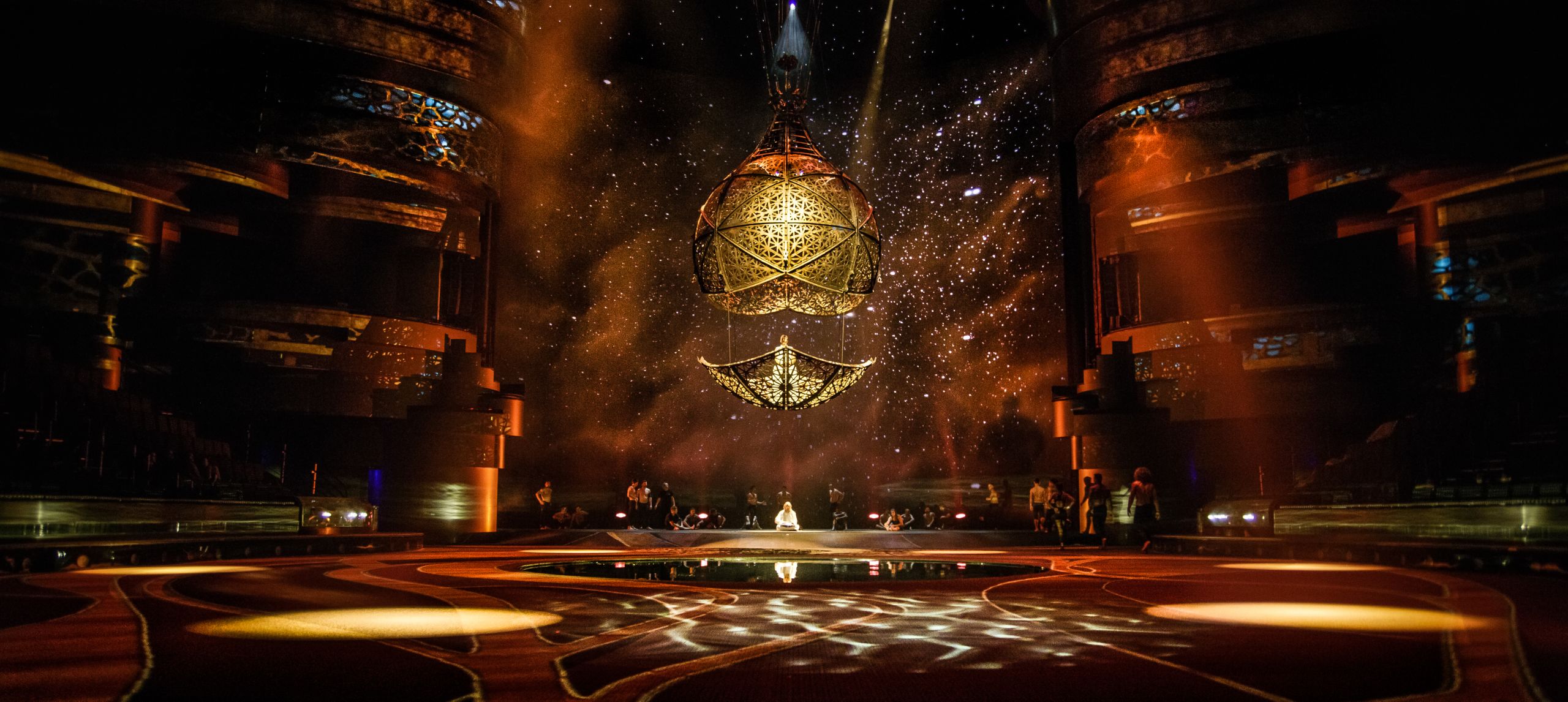 Stage show with large gold ball structure
