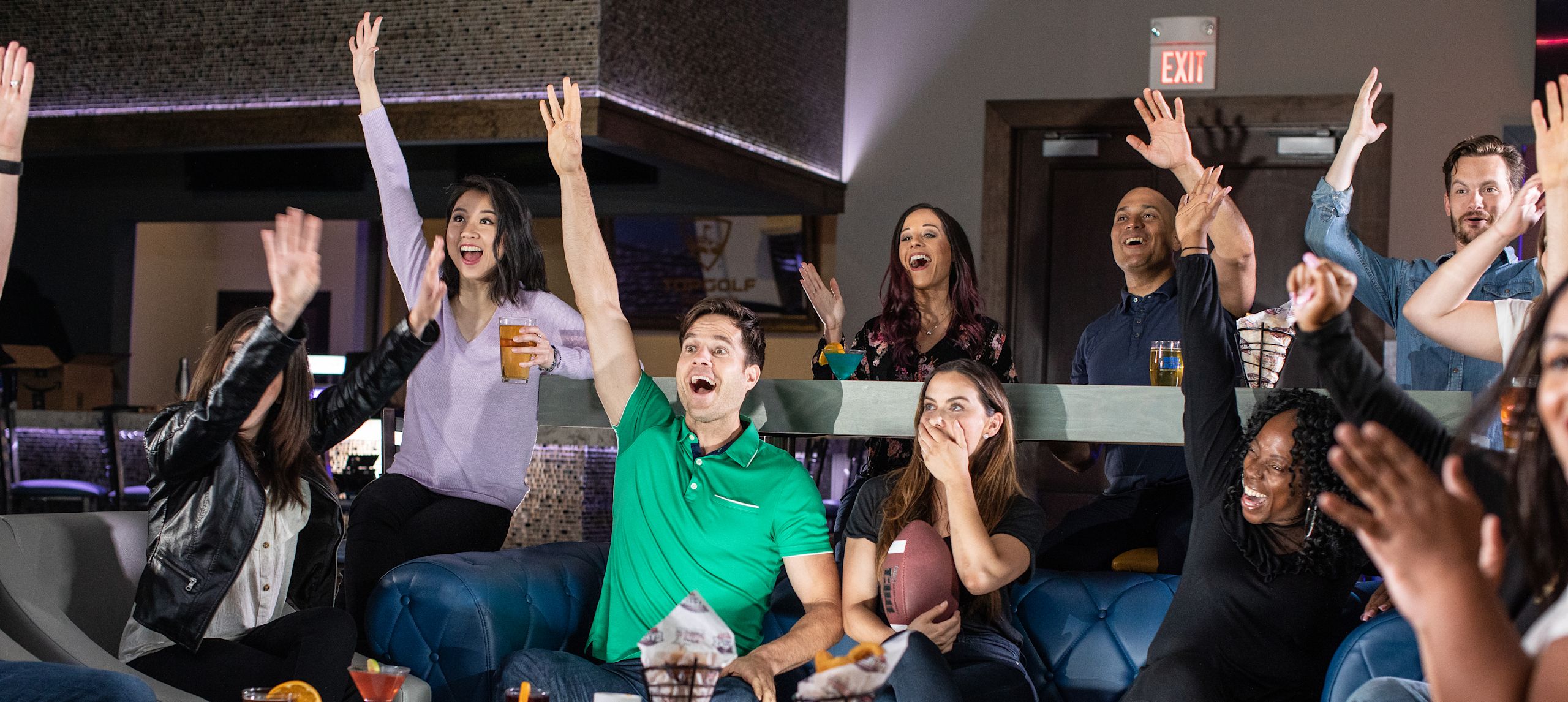 Group of friends with their hands in the air celebrating