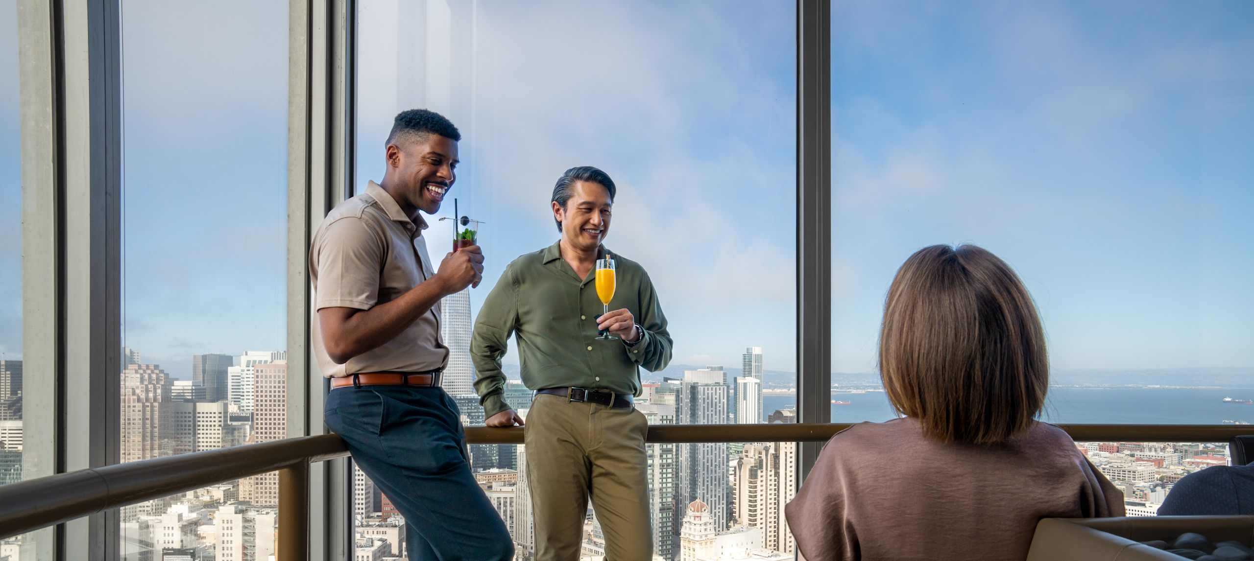 People Enjoying Drinks at Cityscape Sky Bar with Panoramic Views of the City