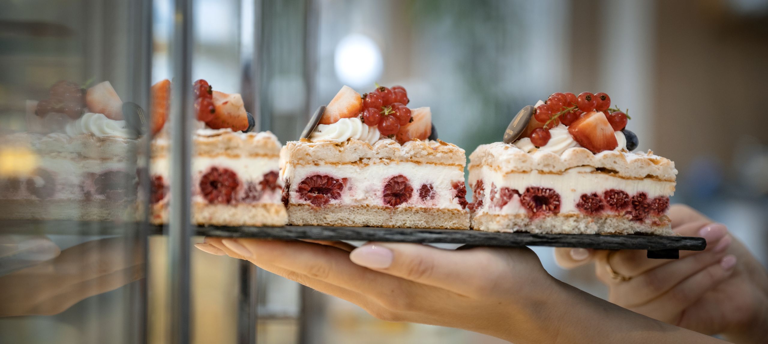 Peron holding tray of desserts