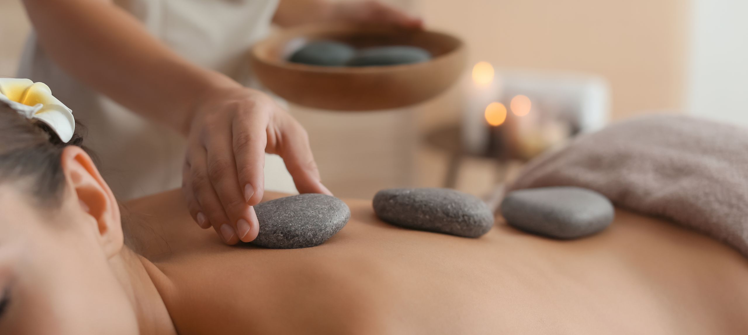 guest receiving a hot stone massage