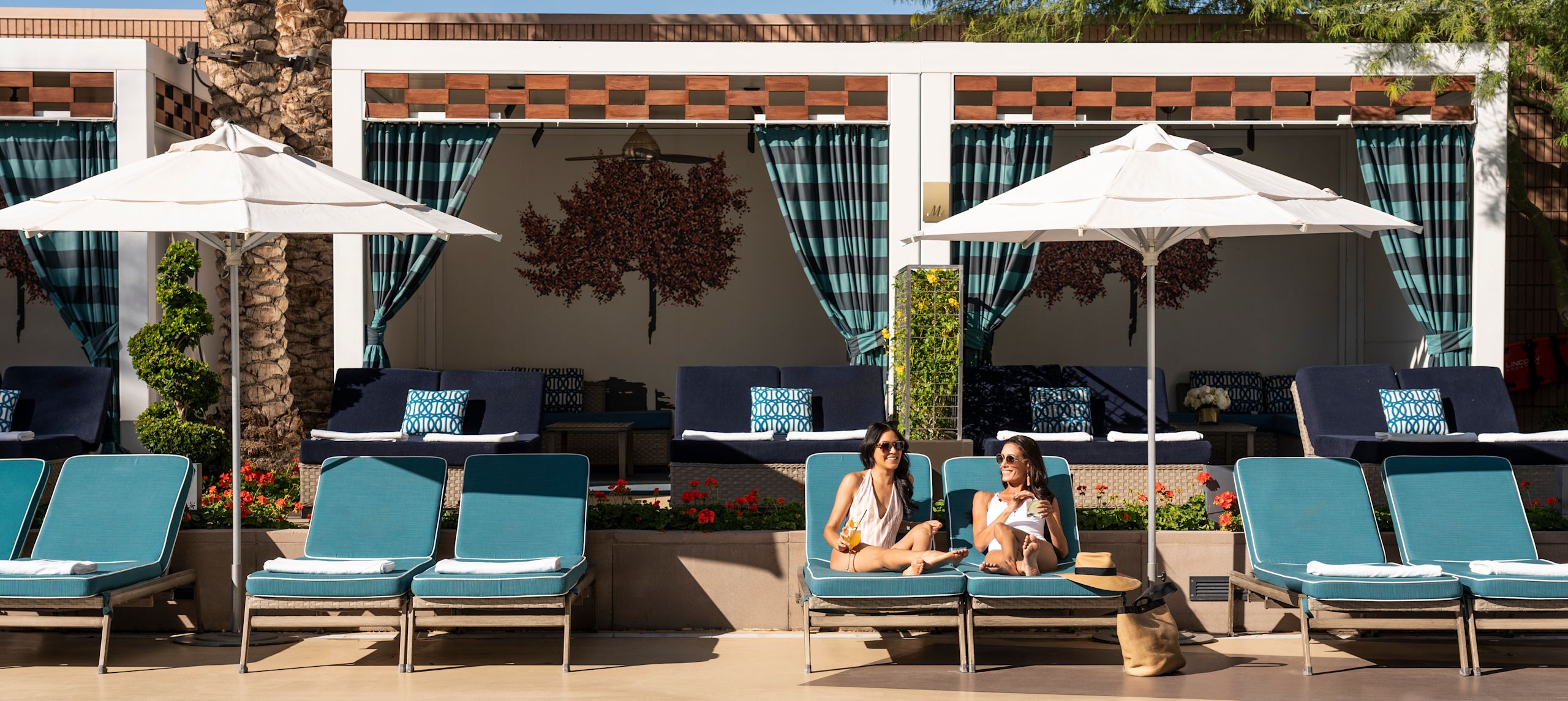 Women Enjoying Drinks and Relaxing in Outdoor Pool Area-transition