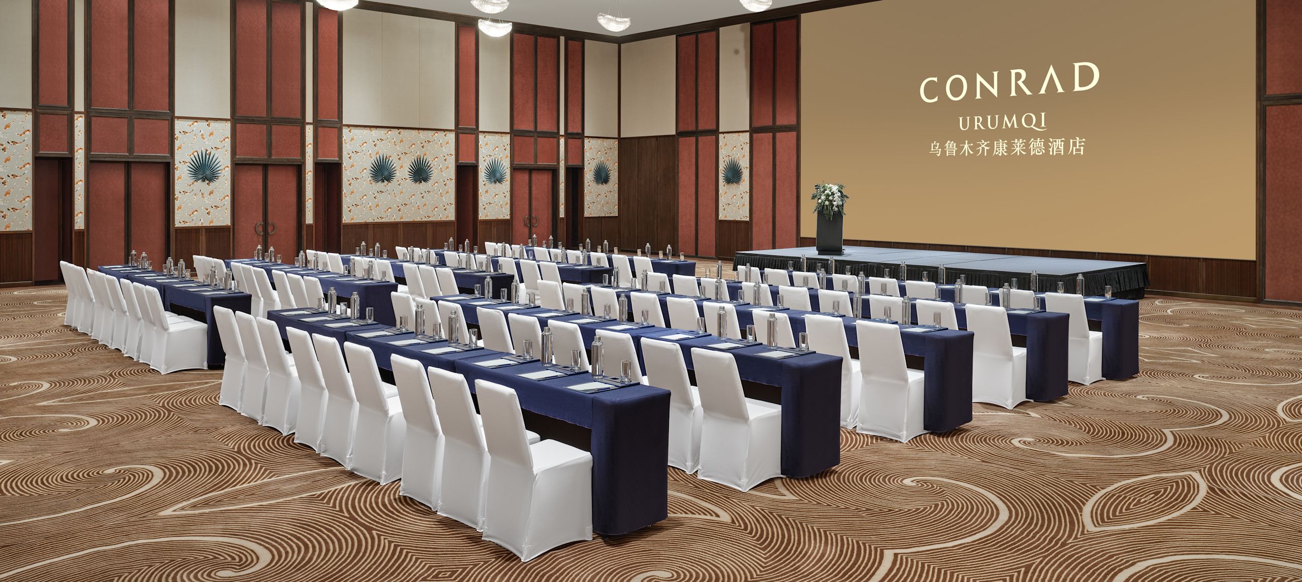 Ballroom with tables, chairs and projector screen