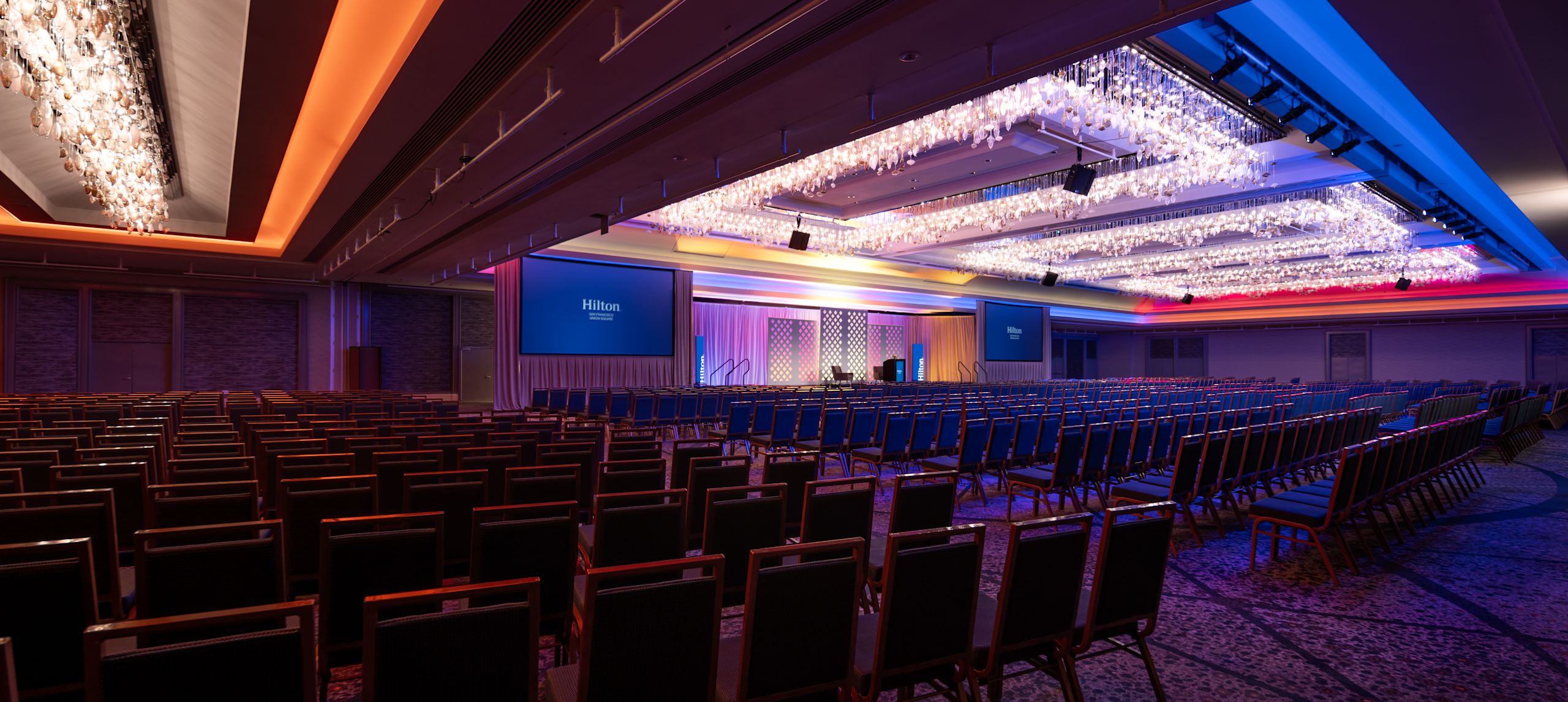 Angle view of the Grand Ballroom setup theater style and decorated with colorful lights