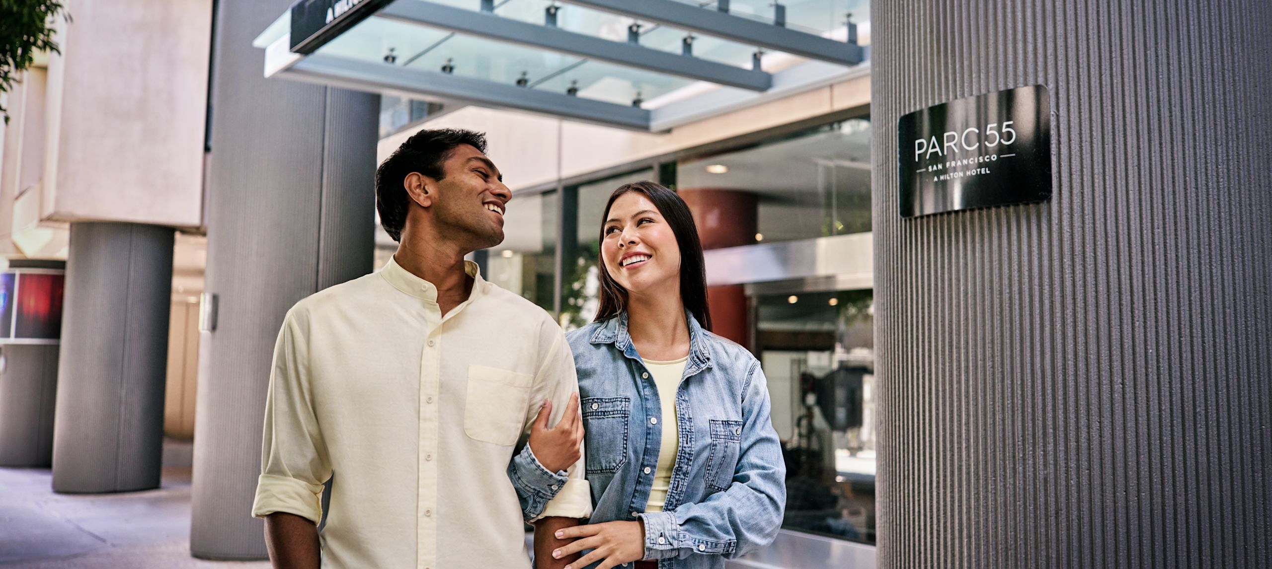 Couple walking around the entrance of Hilton Parc 55