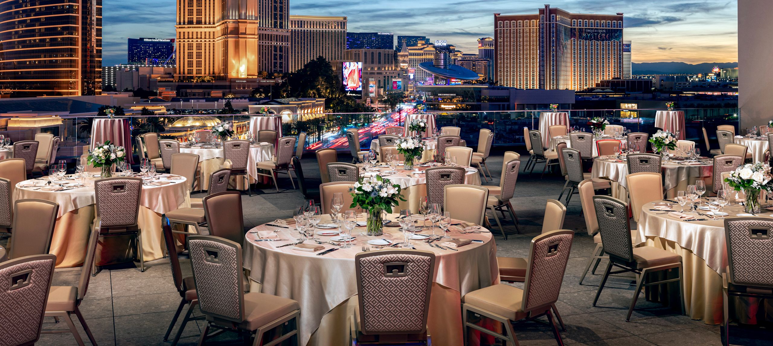 outdoor rooftop reception space with round tables