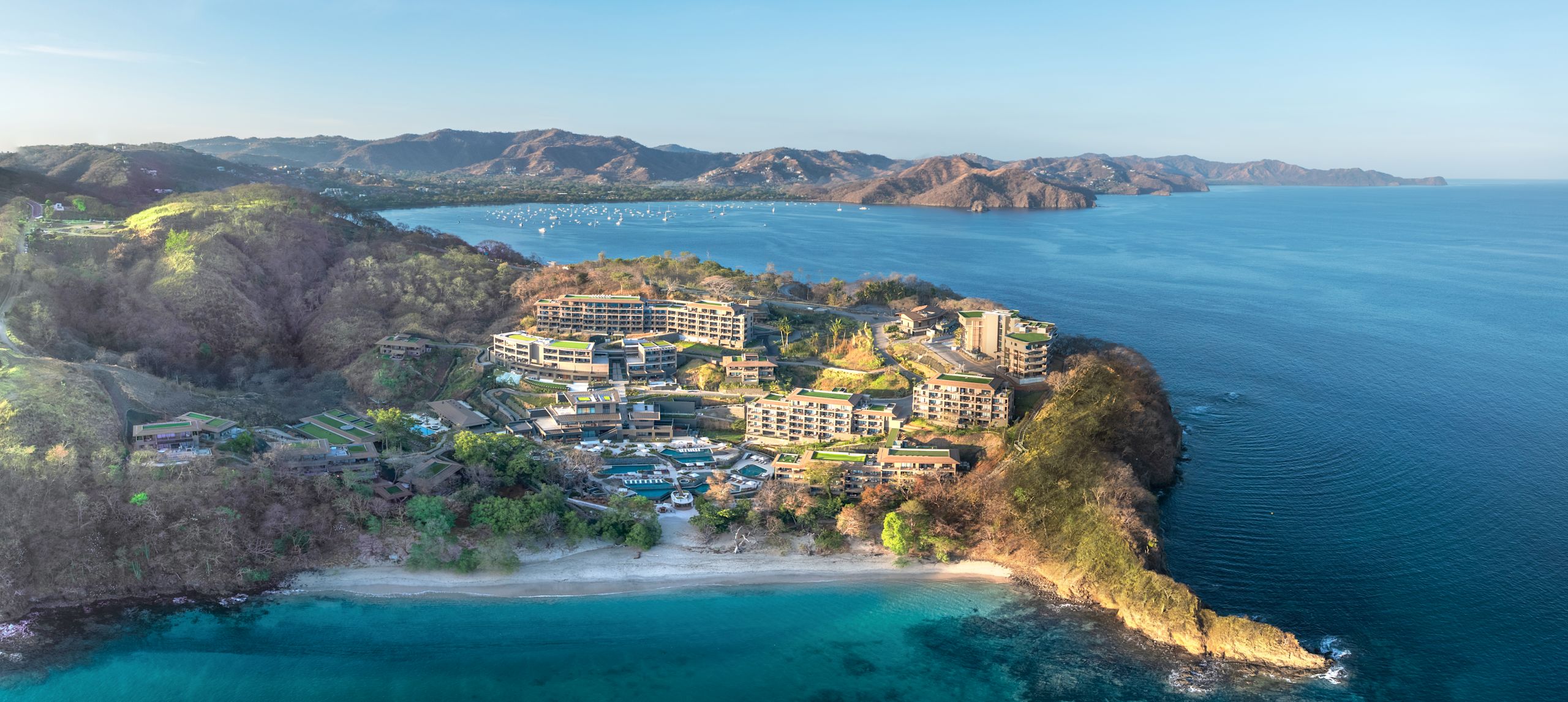 Photo d'un drone de l'extérieur de l'hôtel de loin, montrant l'océan et la côte environnants