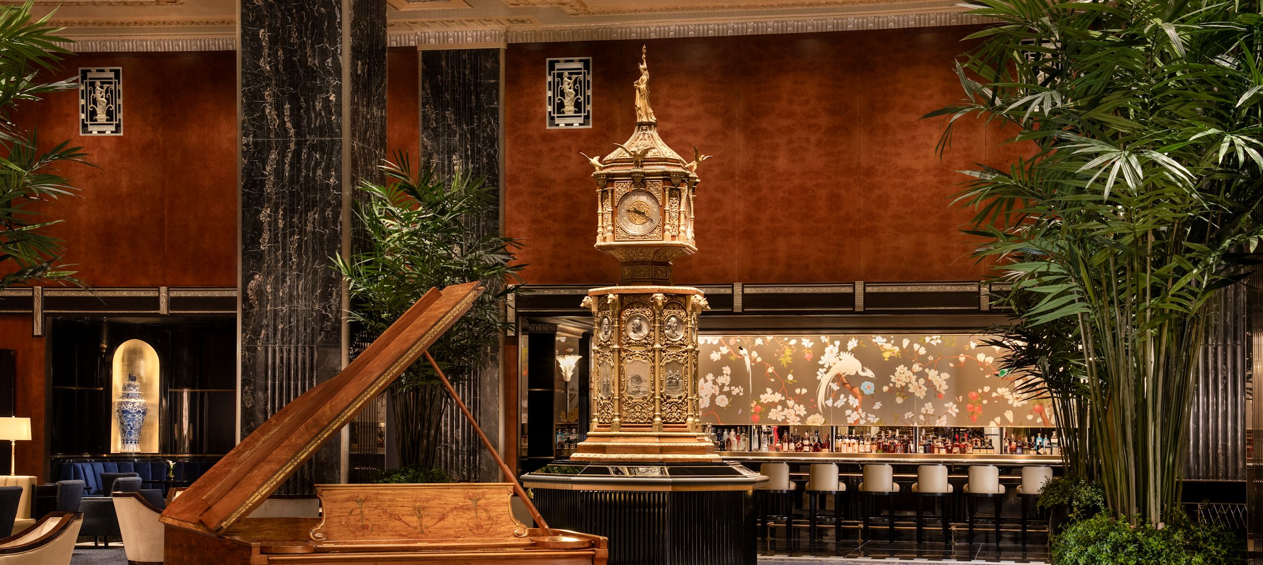 Luxurious lobby with piano, clock and bar area