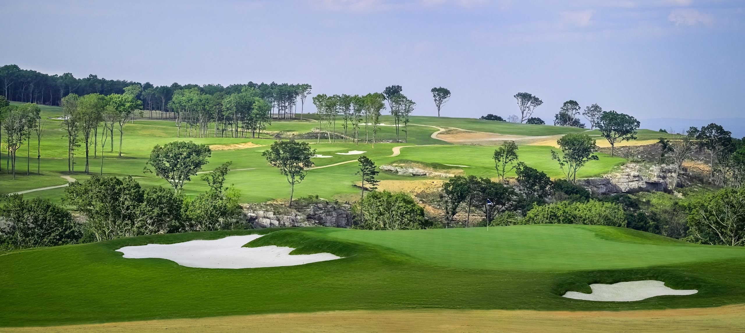 Golf course with water traps and trees