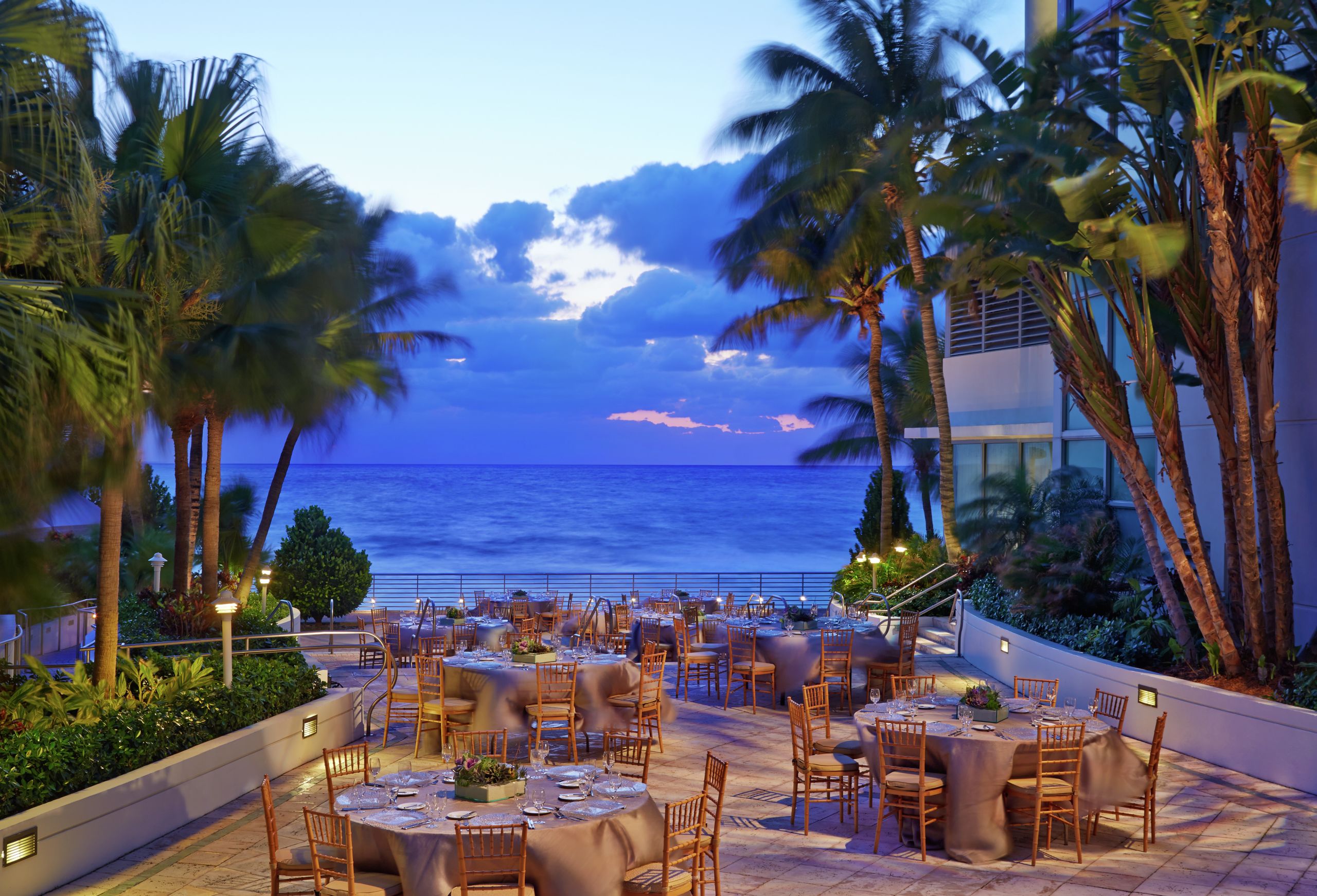 Outdoor event space, banquet tables, ocean view