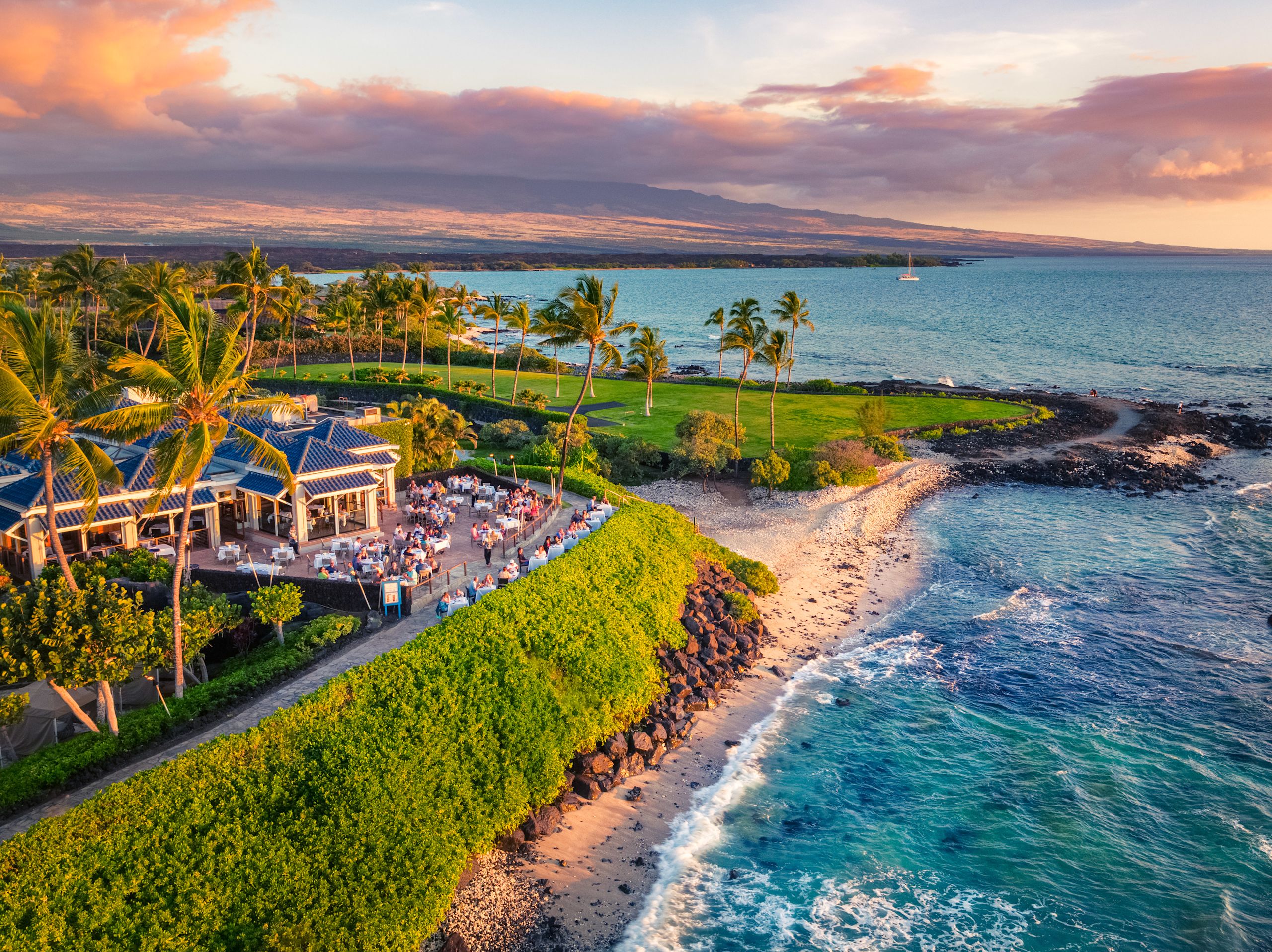 View of resort with surrounding trees and sea