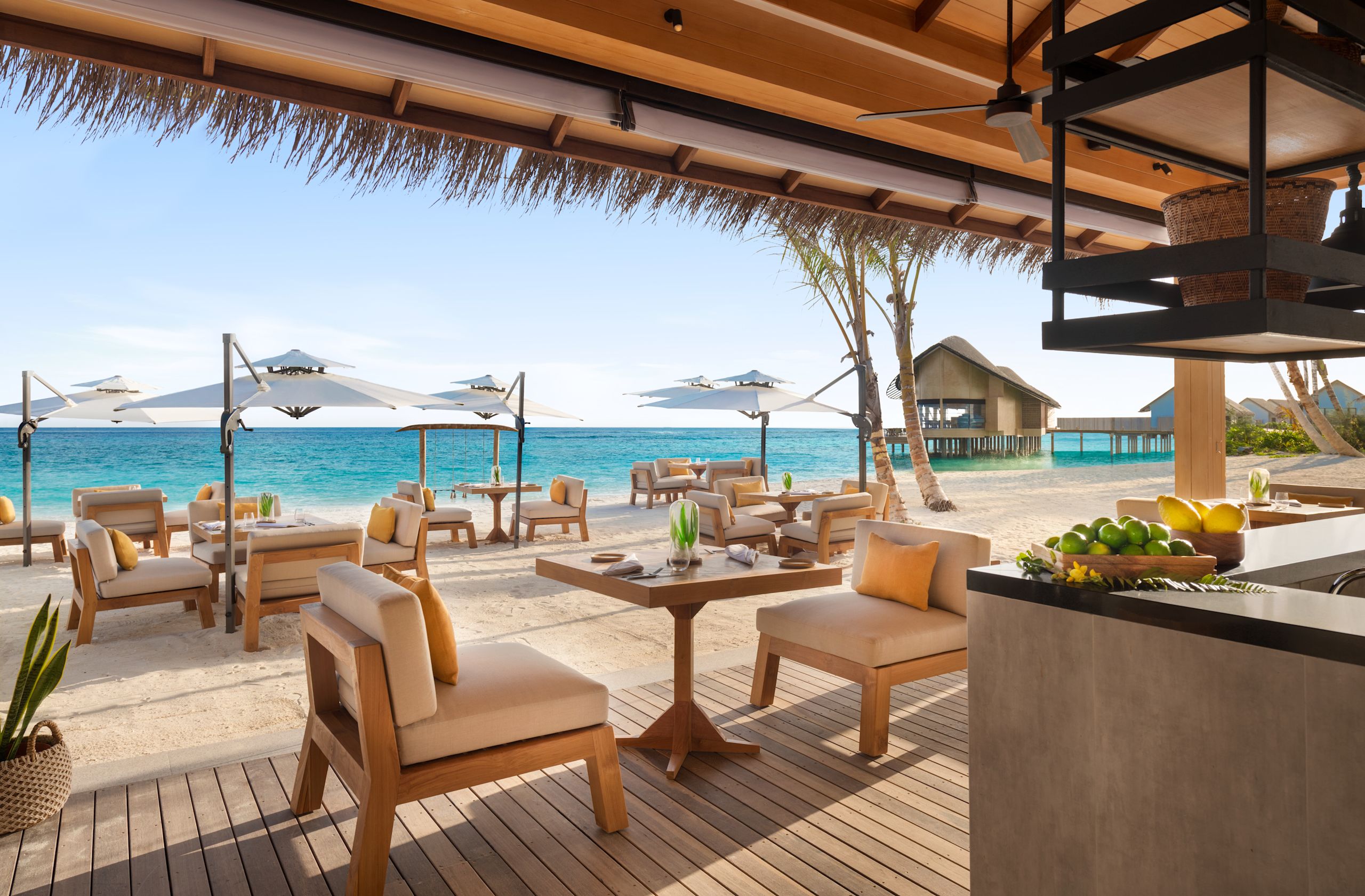 Outdoor bar and seating area on beach with sea view