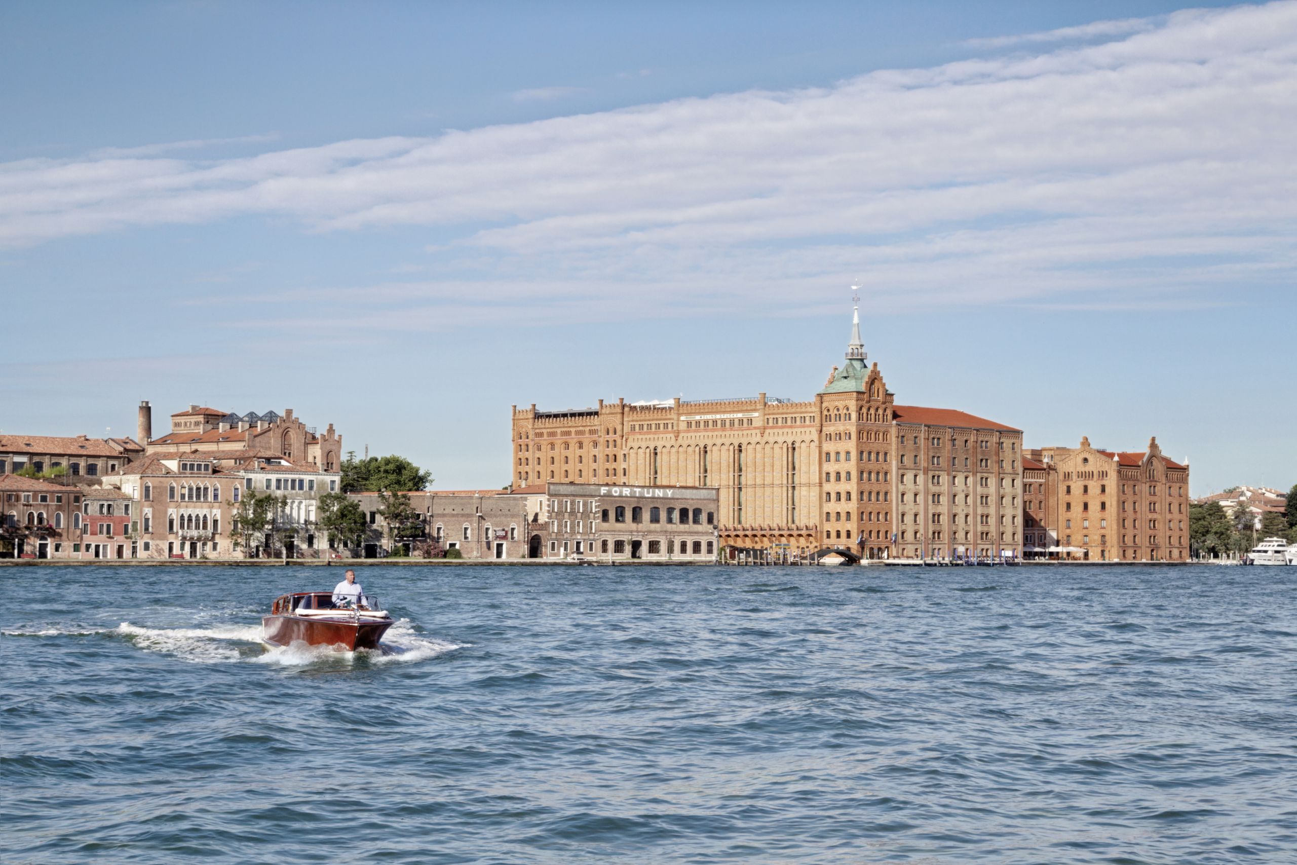 View of Hotel from Water with boats on water