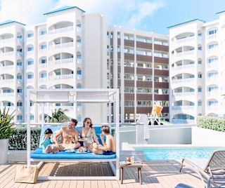 Family sitting in a large covered lounge seat at the Chala Sky Bar.