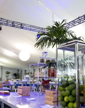 Pavillion Lighting Setup with Table of food with large glass boxes of limes and lemons