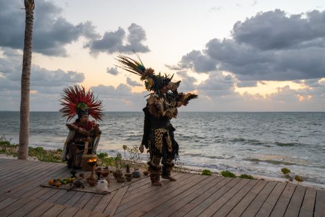 indigenous dancers by ocean