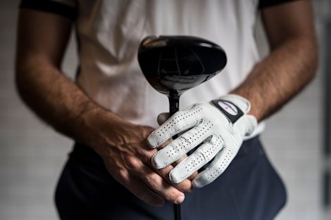 Close up of golfer holding club