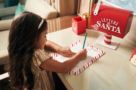 Girl Writing a Letter to Santa in a Guest Room