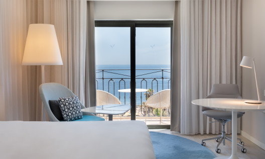 Guest Room with Sea View from Balcony with Seating Area