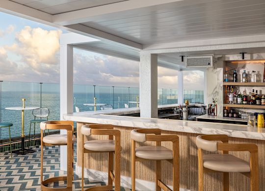Exterior of Nube's bar with tables overlooking the ocean