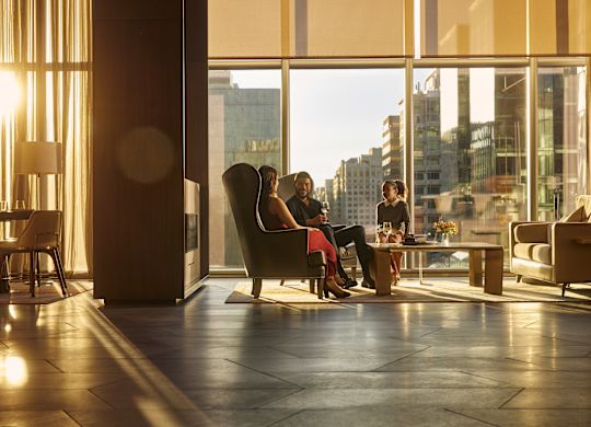 Group of people in lobby area with city view