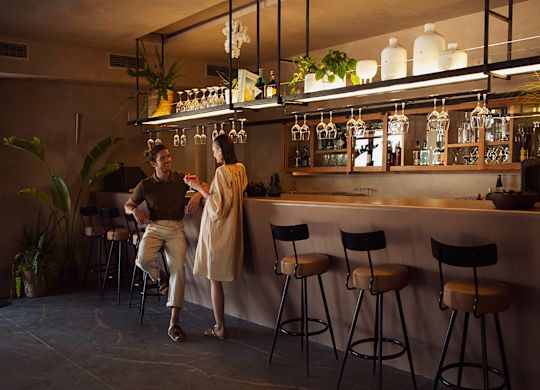 a couple having drinks and talking at Blu Bar